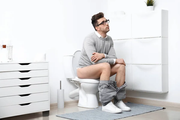 depositphotos_332396306-stock-photo-man-glasses-sitting-toilet-bowl.jpg