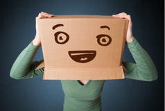 young-woman-gesturing-cardboard-box-her-head-smil-standing-smiley-face-53490831.jpg